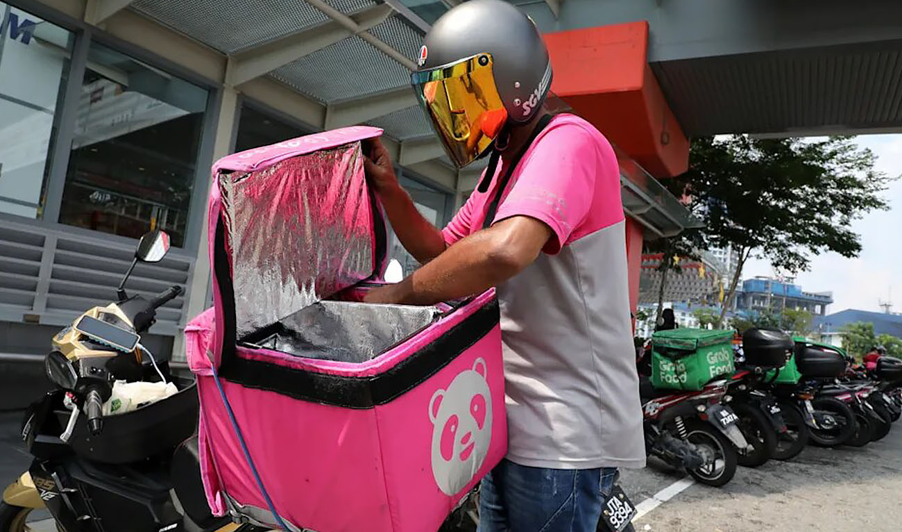 In this undated photo a food panda delivery person is putting food in the delivery bag. (Photo courtesy: REUTERS)