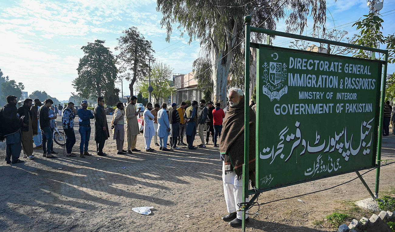 In this picture taken on March 3, 2023, people queue outside the passport office in Gujrat district, in Punjab province. (Photo courtesy: AFP)