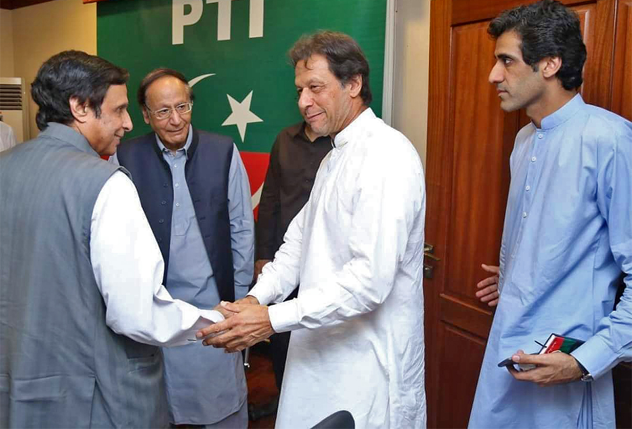 The undated file photo shows Pervez Elahi, left, shaking hands with Pakistan Tehreek-e-Insaf party chairman Imran Khan in Islamabad, Pakistan. (Photo courtesy: social media/File)
