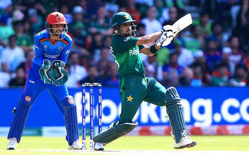 Pakistan's Babar Azam (R) plays a shot as Afghanistan's wicketkeeper Ikram Ali Khil looks on during the 2019 Cricket World Cup group stage match between Pakistan and Afghanistan at Headingley in Leeds, northern England, on June 29, 2019. (AFP/File)