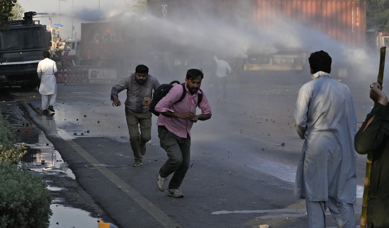 Police officers use water cannon to disperse the supporters of Pakistan's former Prime Minister Imran Khan during clashes, in Lahore, Pakistan, on March 8, 2023. (AP)