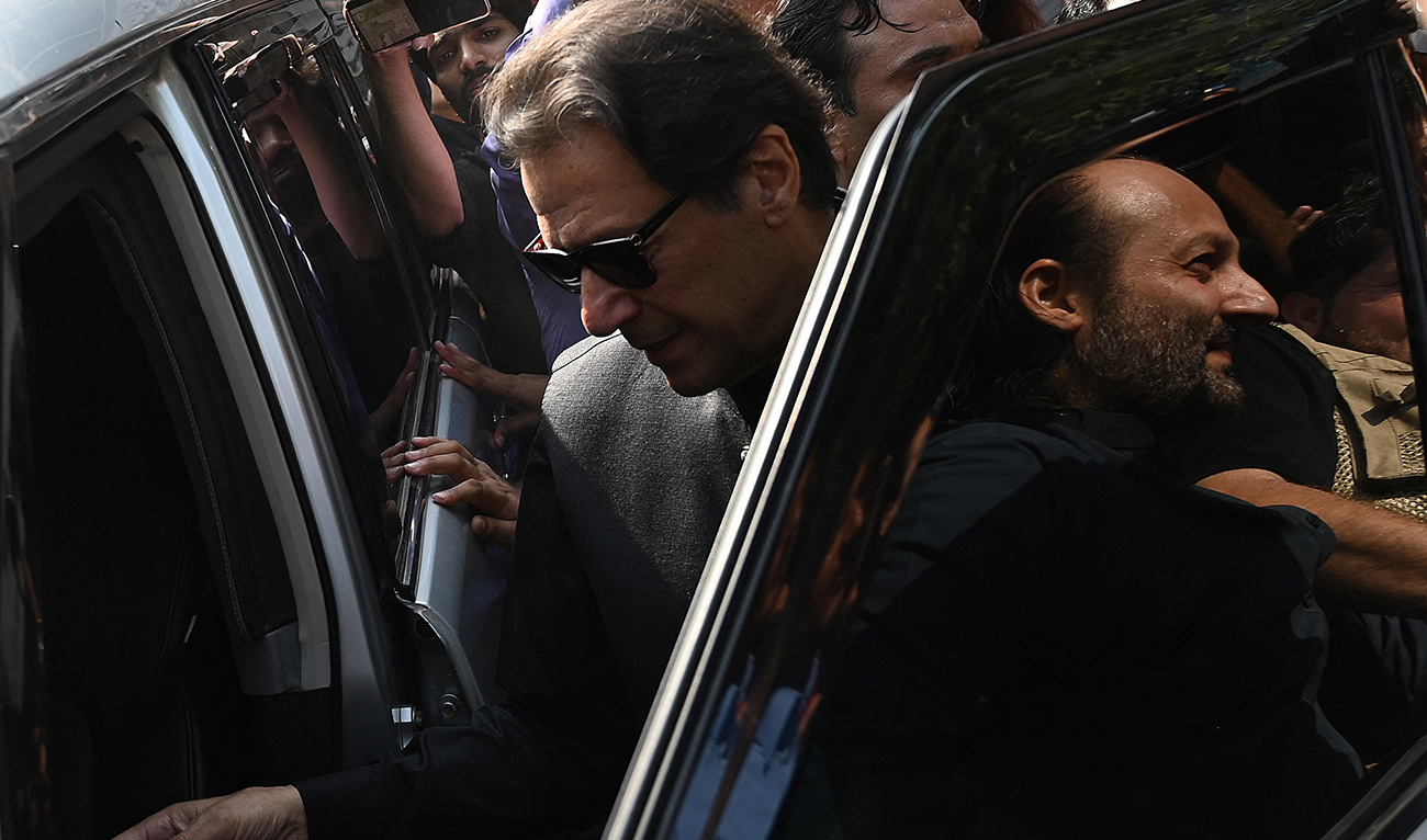 Pakistan's former Prime Minister Imran Khan (L) leaves after appearing before the High Court in Islamabad on September 22, 2022. (AFP/FILE)