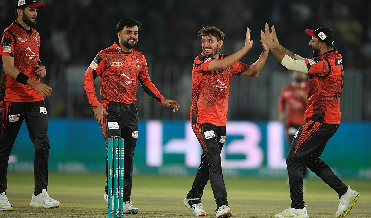 Lahore Qalandars' playres celebrate after dismissal of Islamabad United's Colin Munro (not pictured) during the Pakistan Super League (PSL) T20 cricket match between Islamabad United and Lahore Qalandars at the Rawalpindi Cricket Stadium, in Rawalpindi on March 9, 2023. (AFP)