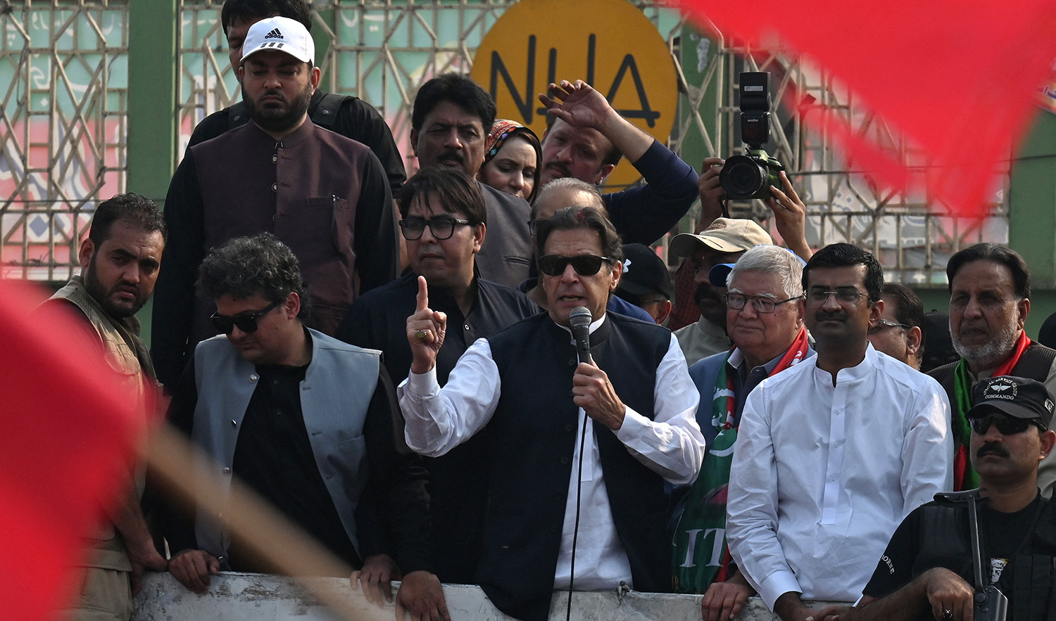 Pakistan's former prime minister Imran Khan, center, addresses his supporters during an anti-government march towards Islamabad city, demanding early elections, in Muridke district, about 29 km from Lahore on October 30, 2022. (AFP/File)