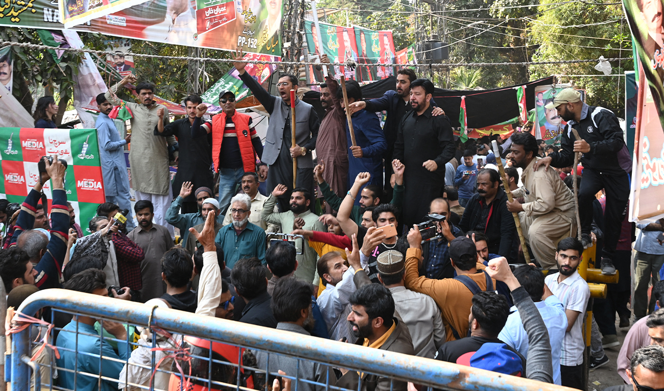 Supporters of former Pakistan's prime minister Imran Khan chant slogans outside his house in Lahore on March 5, 2023. (AFP/File)