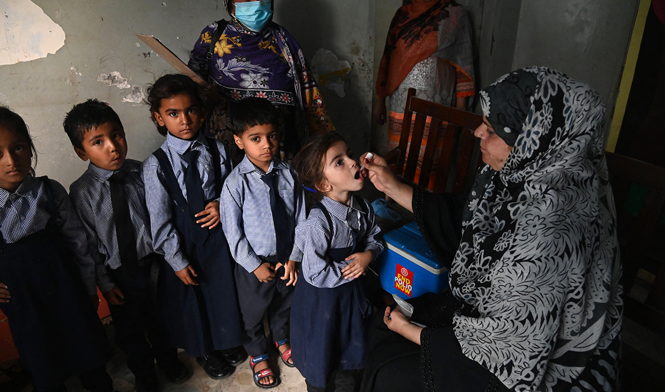 A health worker administers polio vaccine drops to a child during a vaccination campaign in Lahore on October 24, 2022. (AFP/FILE)