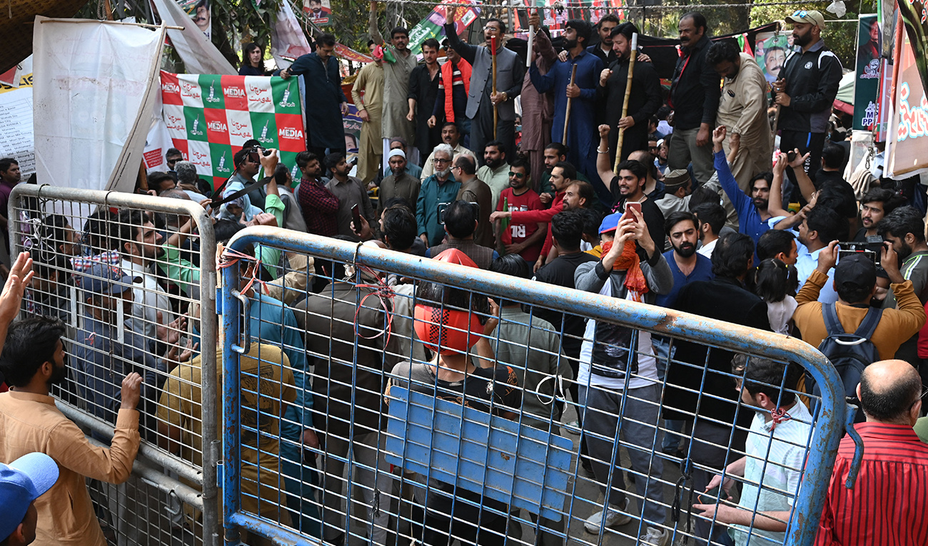 Supporters of former Pakistan's prime minister Imran Khan chant slogans outside his house in Lahore on March 5, 2023. (AFP/FILE)