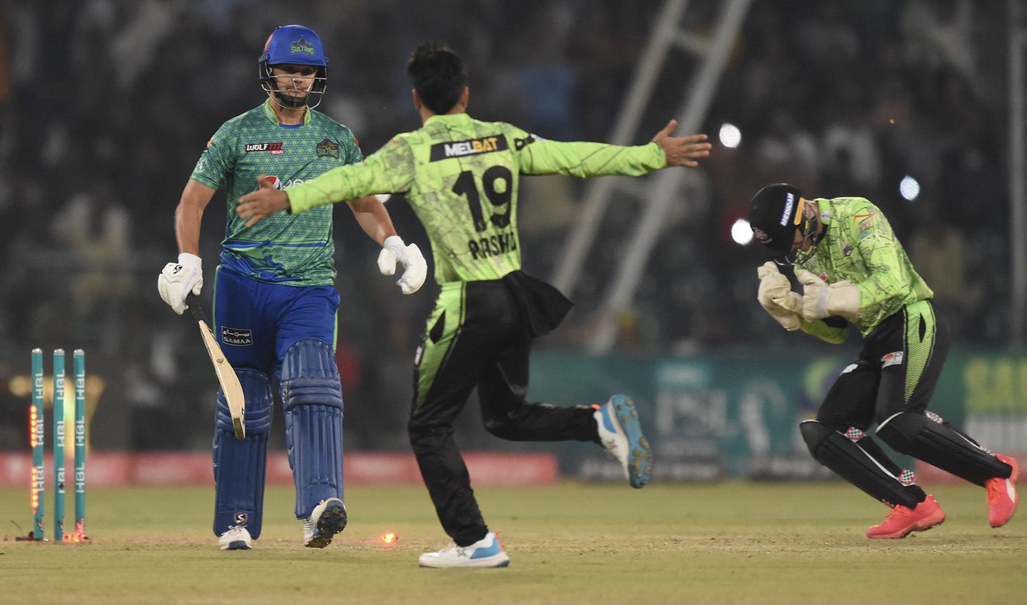 Lahore Qalandars' celebrate the dismissal of Multan Sultans' Rilee Rossouw, left, during a Pakistan Super League (PSL) Twenty20 cricket match at the Gaddafi Cricket Stadium in Lahore on March 4, 2023. (AFP/File)