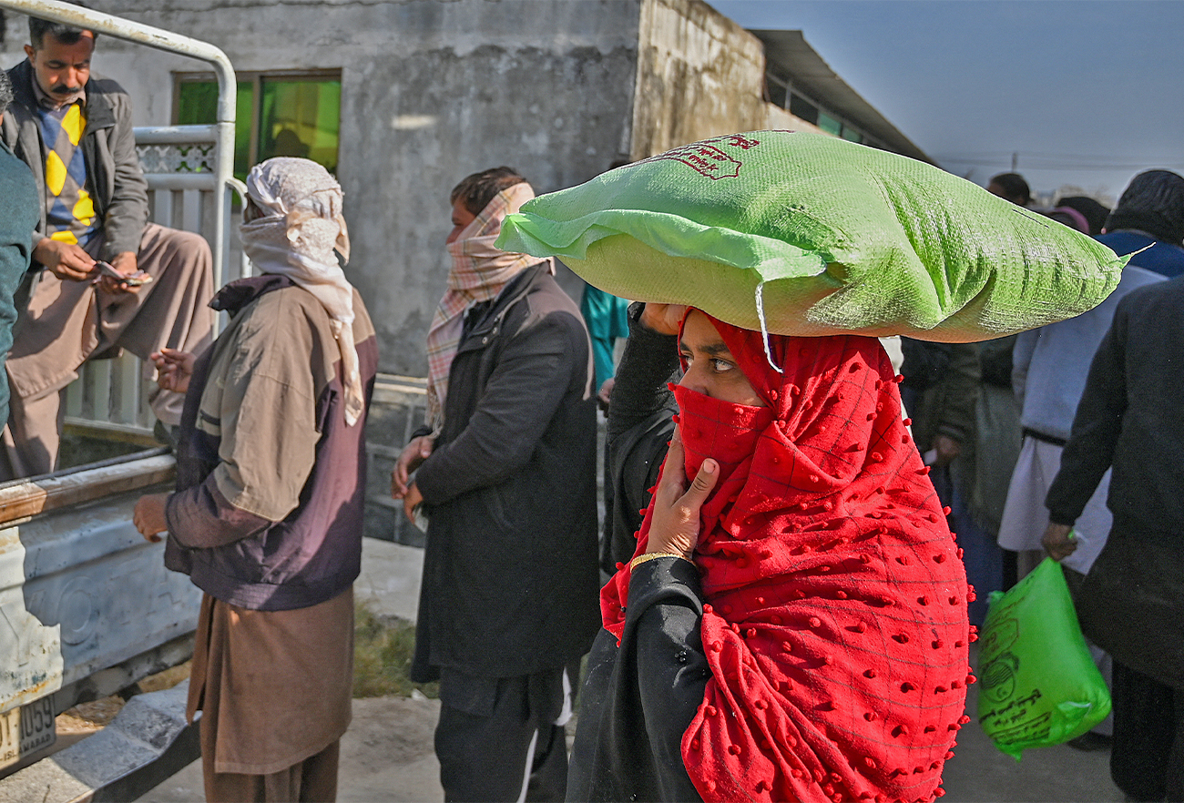 Local residents queue to buy wheat flour at government-controlled prices in Islamabad on January 10, 2023. (AFP/File)