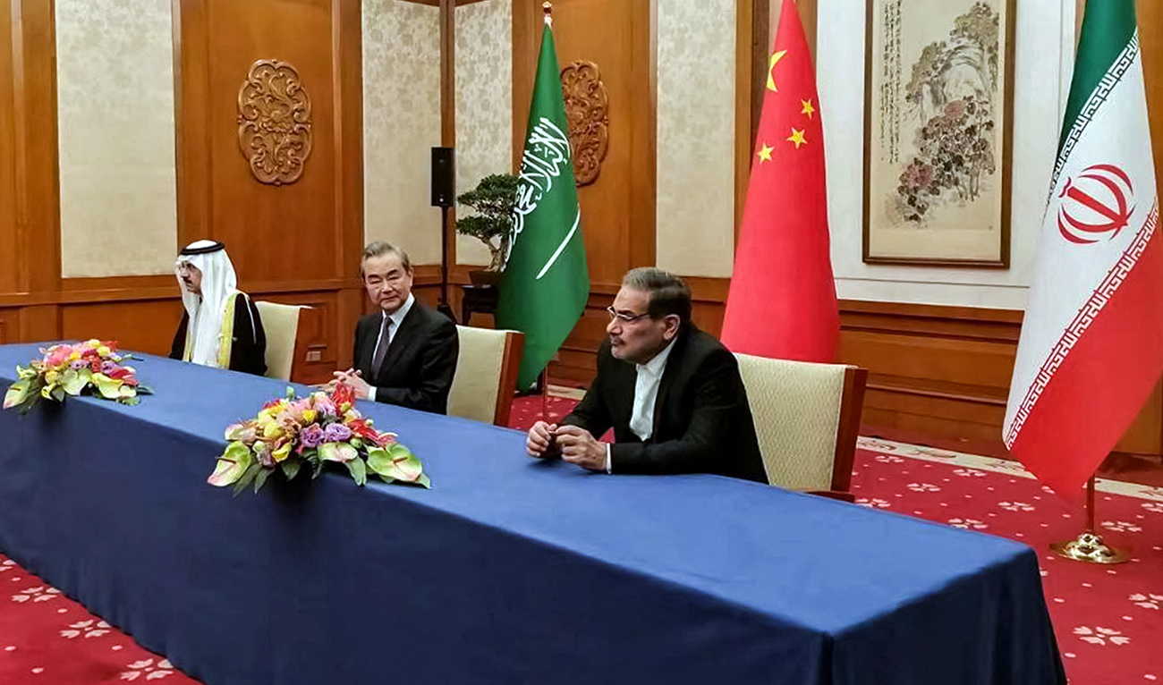 This handout image provided by Nournews agency shows the Secretary of the Supreme National Security Council of Iran Ali Shamkhani (R), the Director of the Office of the Central Foreign Affairs Commission of the Chinese Communist Party (CCP) Wang Yi (C), and Saudi Arabia's National Security adviser and Minister of State Musaad bin Mohammed al-Aiban (L) meeting together in Beijing on March 10, 2023. (AFP/FILE)