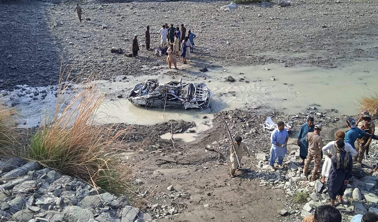 Residents look at the wreckage of a vehicle in the Awaran district of Pakistan's Balochistan province on March 18, 2023. (Photo courtesy: District Administration Awaran)