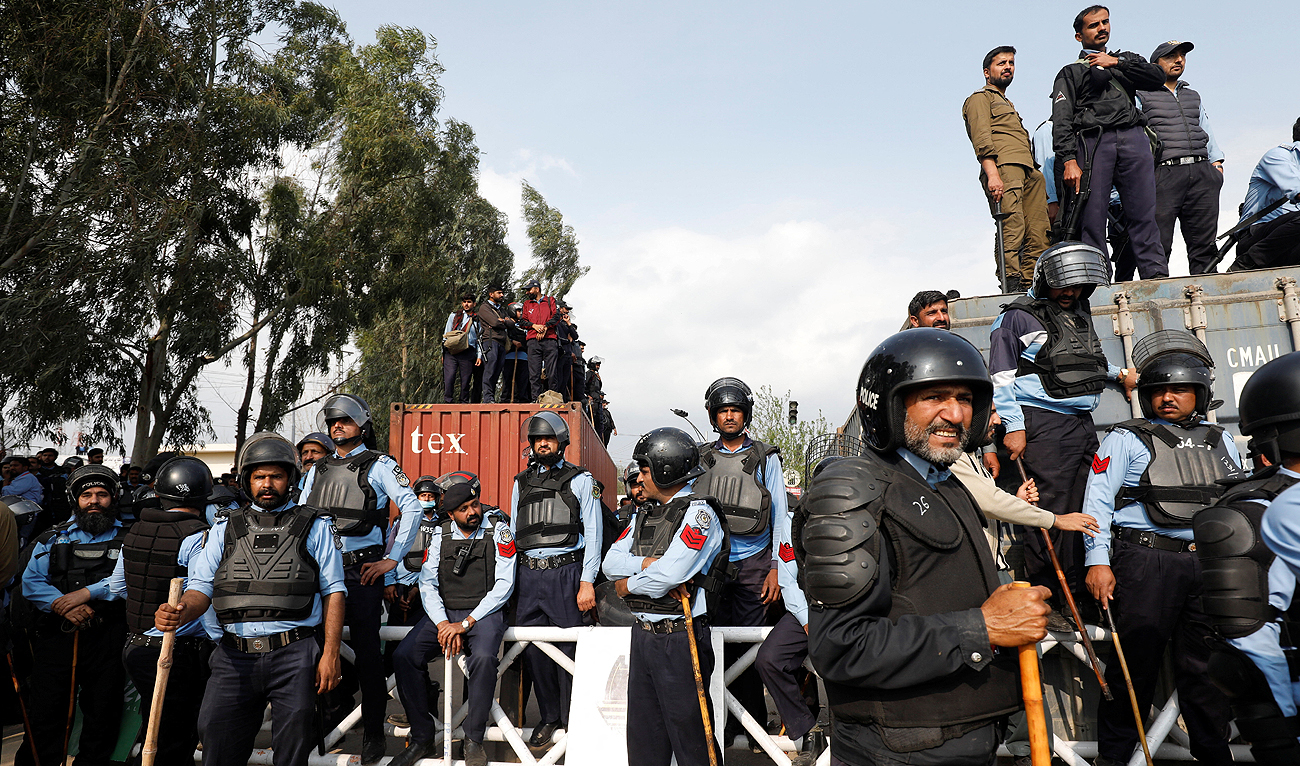 This photo, taken on March 18, 2023, shows members of police standing guard outside a court before the arrival of former Pakistani Prime Minister Imran Khan at the court in Islamabad, Pakistan. (Photo courtesy: REUTERS/File)