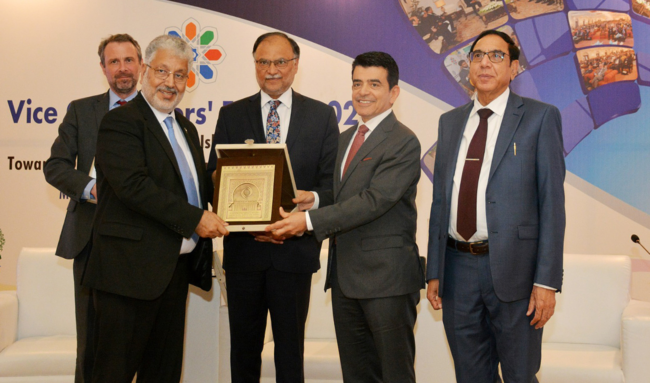 Pakistan's planning and development minister Ahsan Iqbal (center) attends a presentation of a shield by the Chairman of the Higher Education Commission Dr. Mukhtar Ahmed (left) and the director general of the Islamic World Educational, Scientific and Cultural Organization Dr. Salim Muhammad Al-Malik (second right) and other officials after the conclusion of two-day vice chancellor's forum in Islamabad on March 20, 2023. (Photo courtesy: HEC)