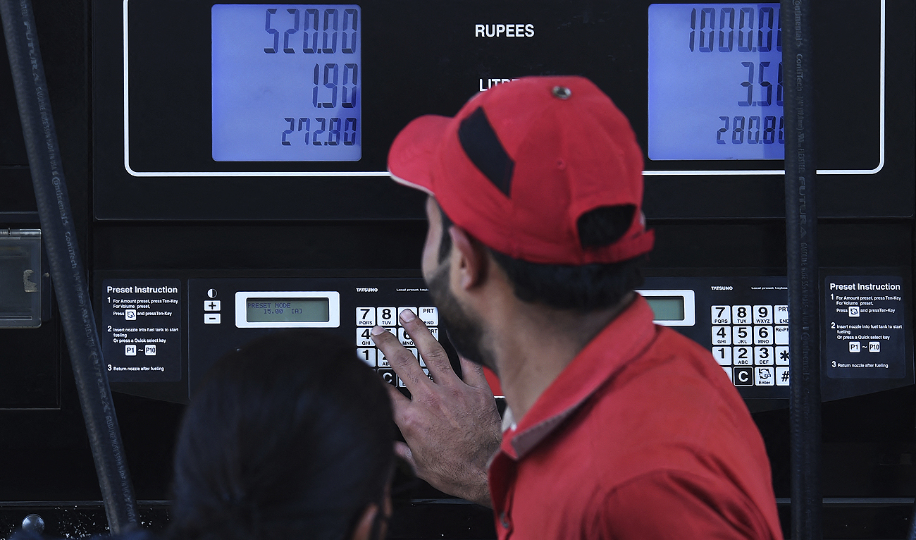An employee of a petrol station fills the tank of a customer in Karachi on February 16, 2023. (Photo courtesy: AFP/File)