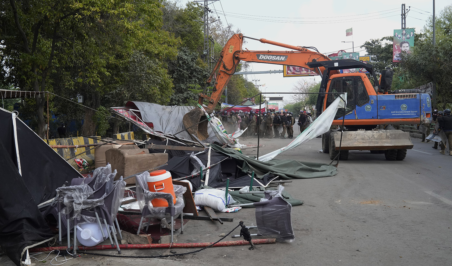 Police use a crane to remove tents and other stuff from outside the residence of former Prime Minister Imran Khan during a search operation in the Khan's resident, in Lahore, Pakistan, on March 18, 2023. (AP)
