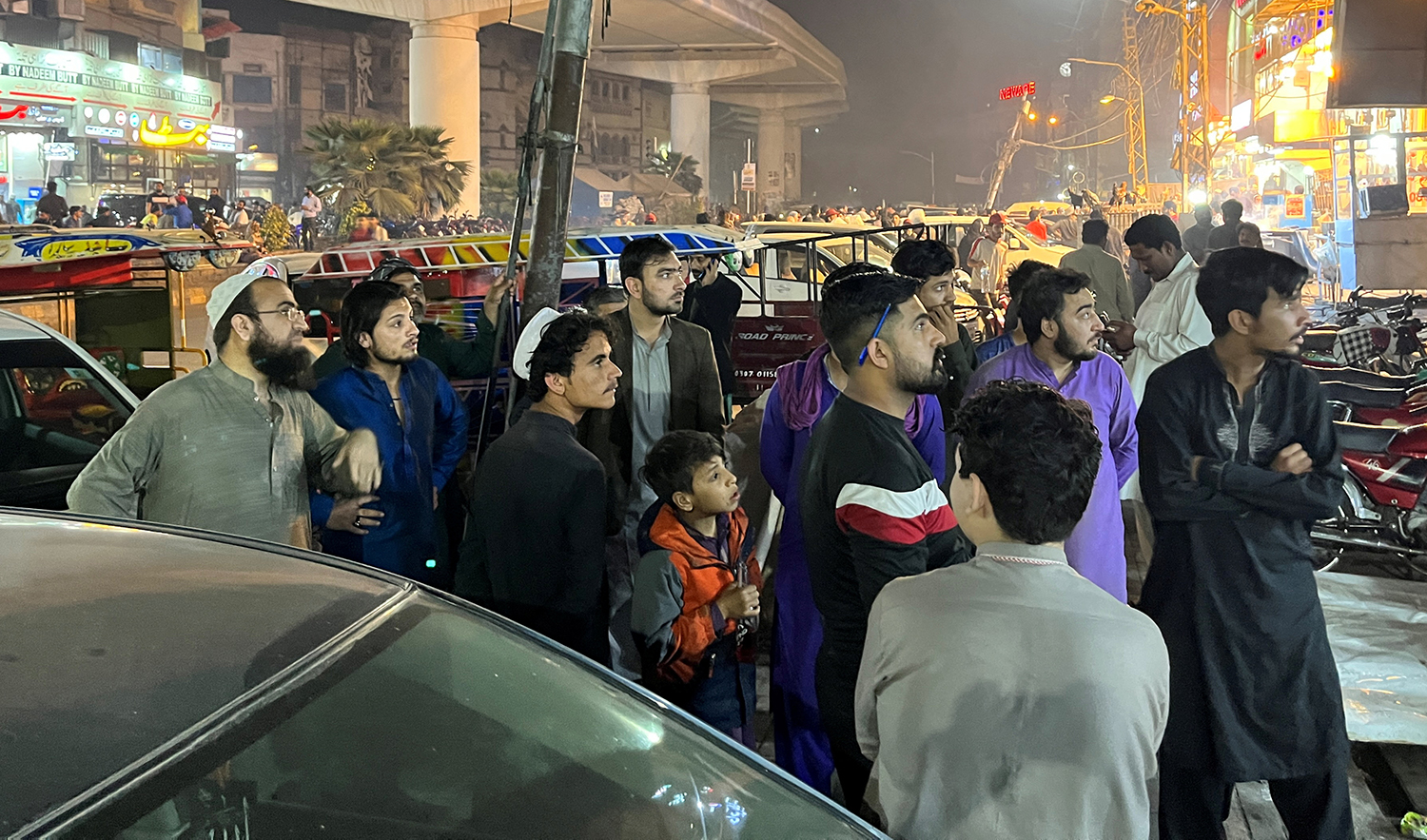 People come out of a restaurant after a tremor was felt in Lahore, Pakistan on March 21, 2023. (REUTERS)