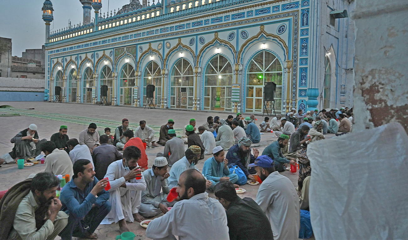 Muslim devotees break their fast on the first day of the Islamic holy month of Ramadan, at the Jamia Mosque in Rawalpindi, Pakistan, on April 14, 2021. (AFP/File)