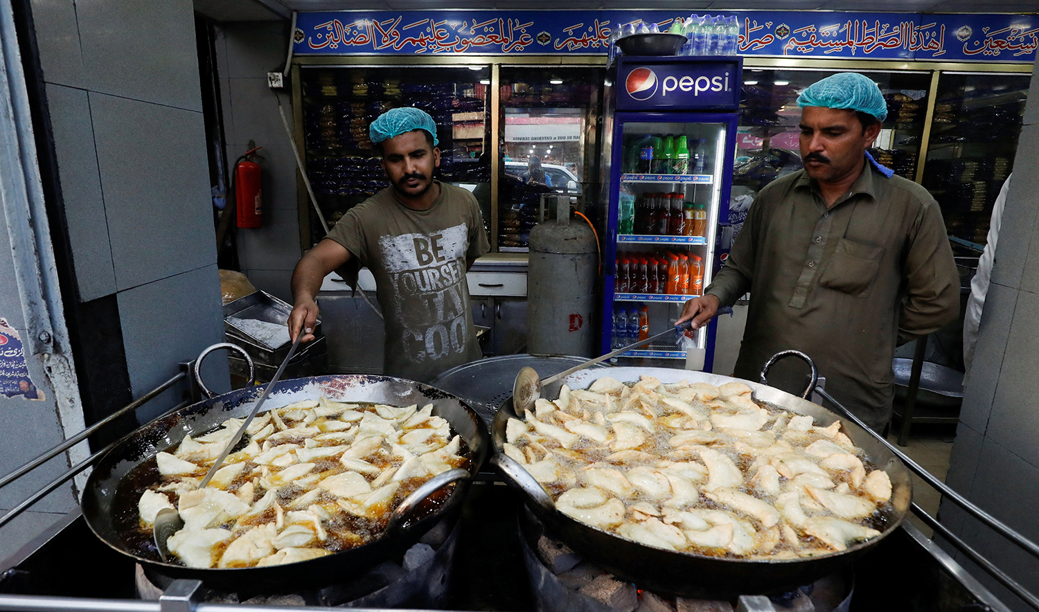 Men prepare traditional delicacies for Iftar during the fasting month of Ramadan, in Karachi, Pakistan on March 23, 2023. (REUTERS)