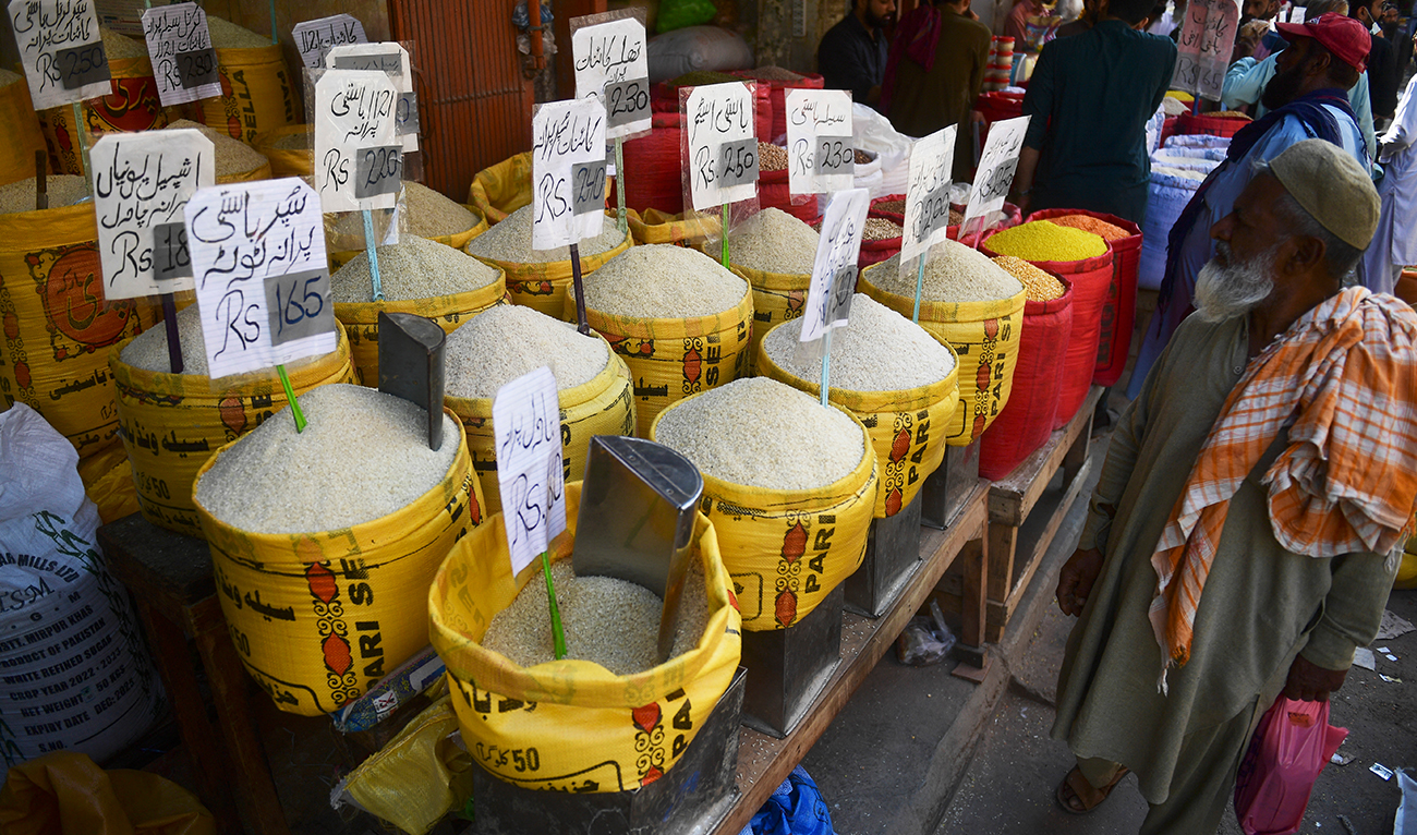A man looks at rice prices at a market in Karachi on February 3, 2023. (AFP/FILE)