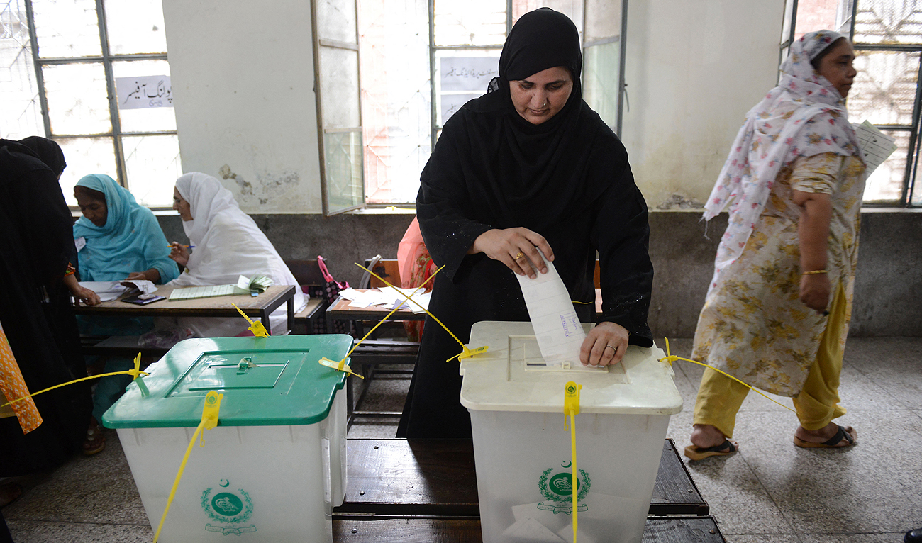 In this file photo, taken on July 25, 2018, A woman casts her vote during Pakistan's general election at a polling station during the general election in Lahore. (Photo courtesy: AFP/File)