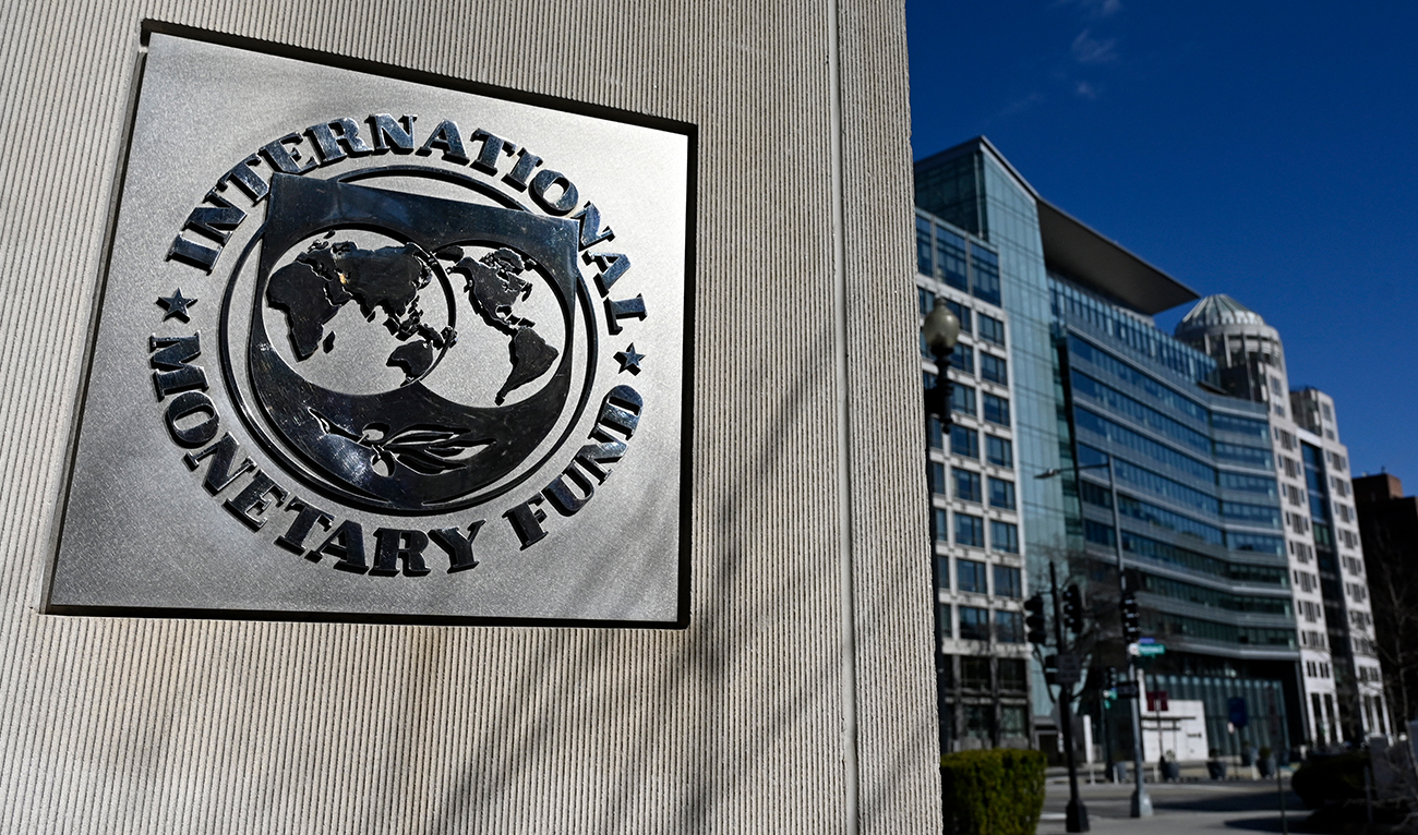 The seal for the International Monetary Fund is seen in Washington, DC, on January 26, 2022. The Omicron variant of Covid-19 is creating an obstacle course for the global economy, which will slow growth this year, notably in the world's two largest economies, the IMF said January 25, 2022. (AFP/FILE)