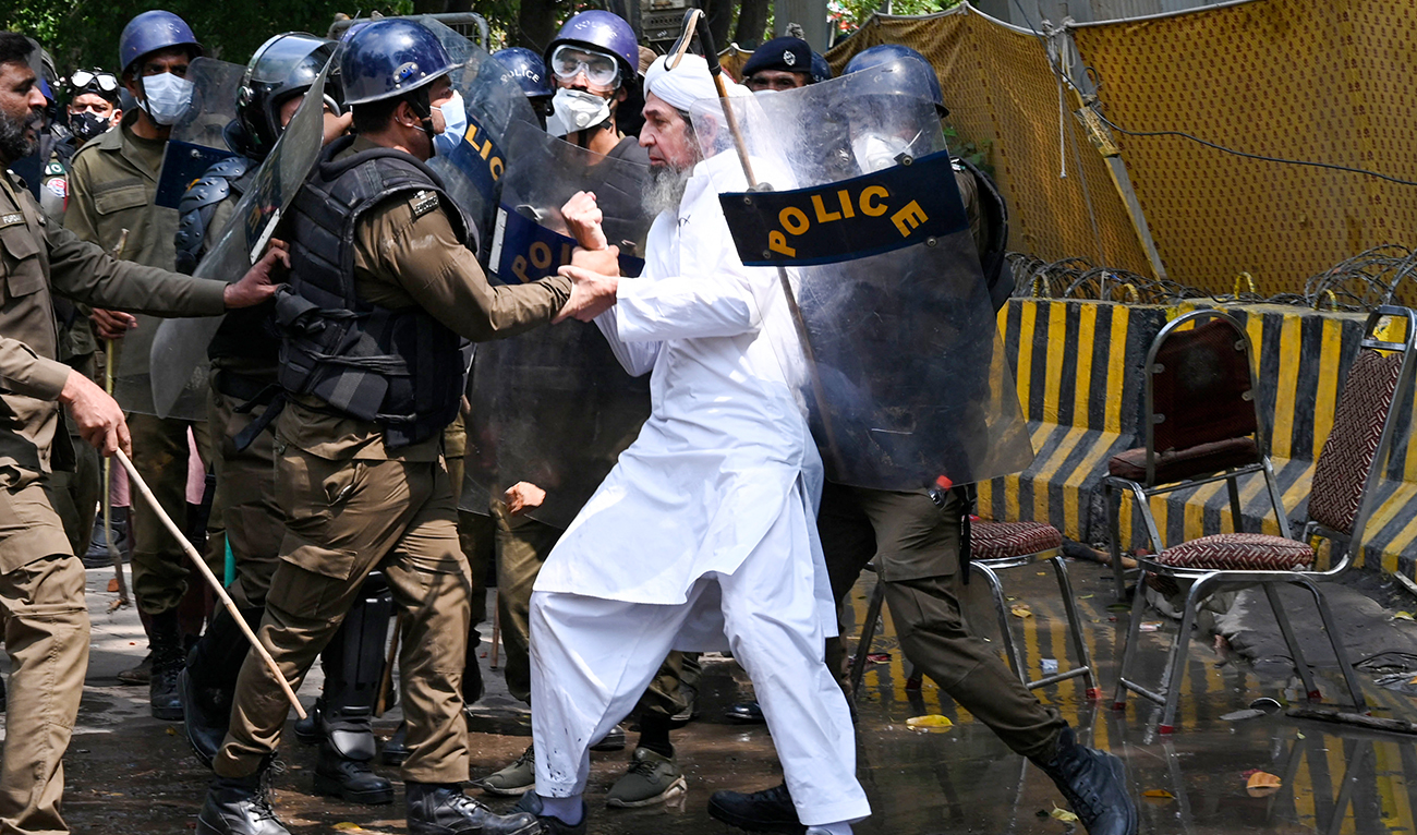Riot police detain a supporter of Pakistan’s former prime minister Imran Khan, in Lahore on March 18, 2023, whilst Khan was leaving for Islamabad to appear in a court. Pakistan's former prime minister Imran Khan said on March 18 he expected to be arrested as he headed to court on graft charges, after days of legal wrangling and pitched battles between his supporters and police. (AFP/FILE)
