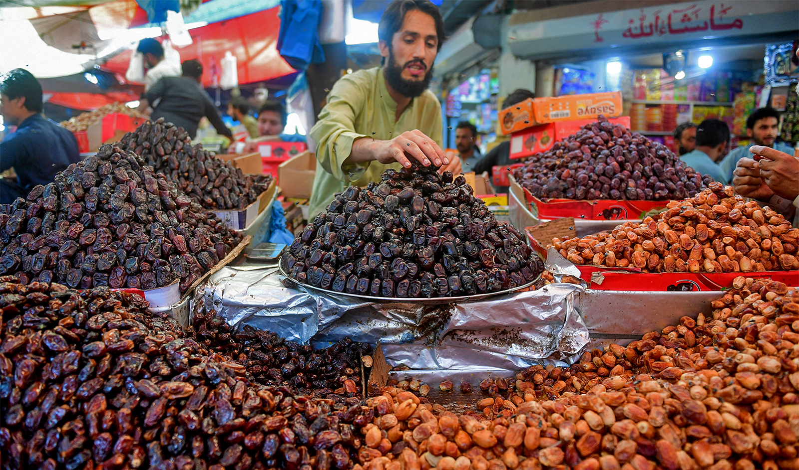 A vendor arranges dates at his stall in a market ahead of the Muslim holy fasting month of Ramadan in Karachi on March 20, 2023. (AFP/File)