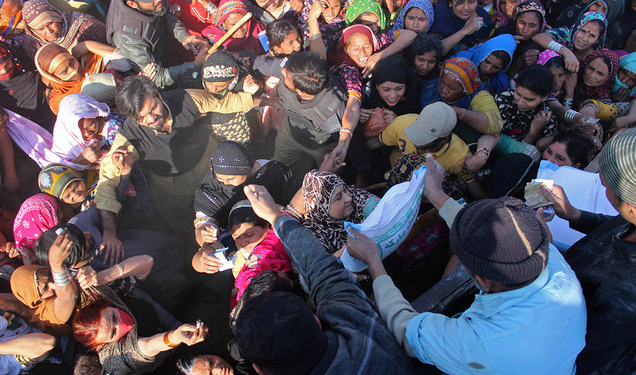 Local residents gather to purchase government-priced wheat flour at Hyderabad in Sindh province on January 9, 2023. (AFP/File)