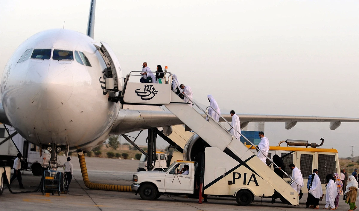 In this file photo, taken on September 30, 2011, Pakistani Muslims board a Pakistan International Airlines (PIA) aircraft to Mecca in Saudi Arabia, for the annual Hajj pilgrimage from Quetta International airport in Quetta. (Photo courtesy: AFP/File)