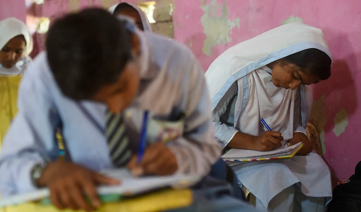 Pakistani students attend a class at a government secondary school in the flood-affected Dadu district of Sindh province on October 28, 2022. (AFP/File)