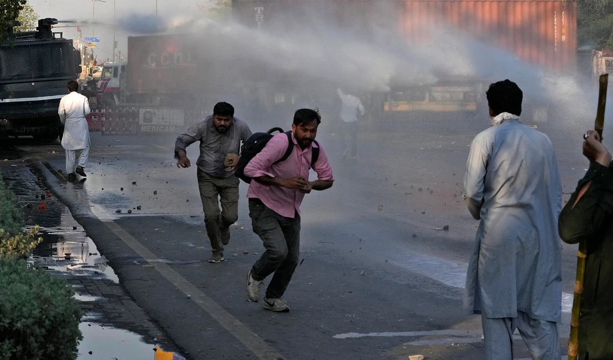 Police officers use water cannon to disperse the supporters of Pakistan's former Prime Minister Imran Khan during clashes, in Lahore, Pakistan, on March 8, 2023. (AP)