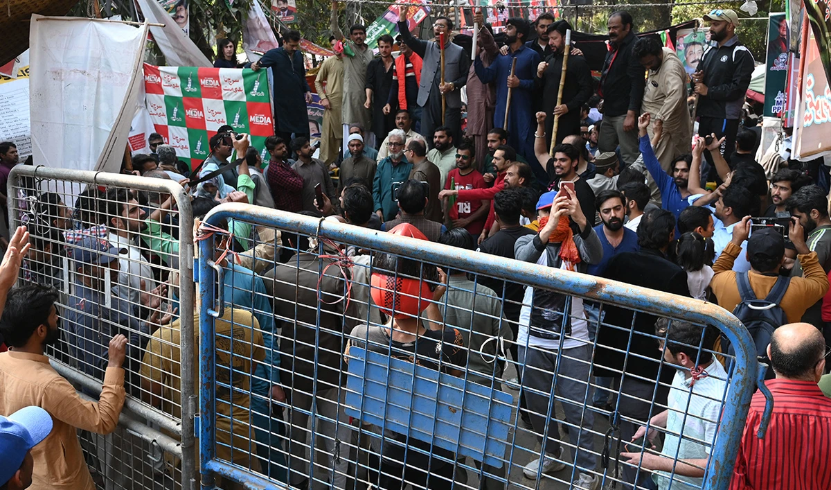 Supporters of former Pakistan's prime minister Imran Khan chant slogans outside his house in Lahore on March 5, 2023. (AFP/FILE)
