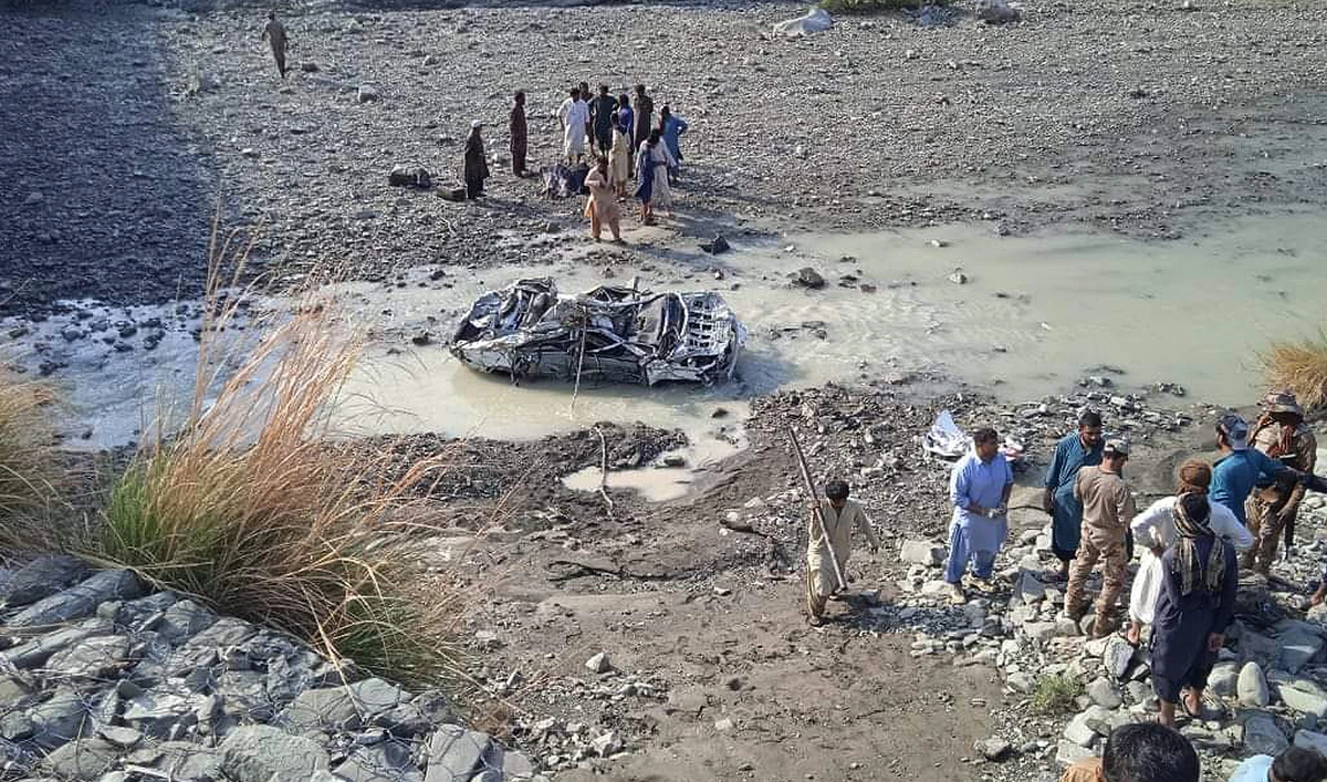 Residents look at the wreckage of a vehicle in the Awaran district of Pakistan's Balochistan province on March 18, 2023. (Photo courtesy: District Administration Awaran)