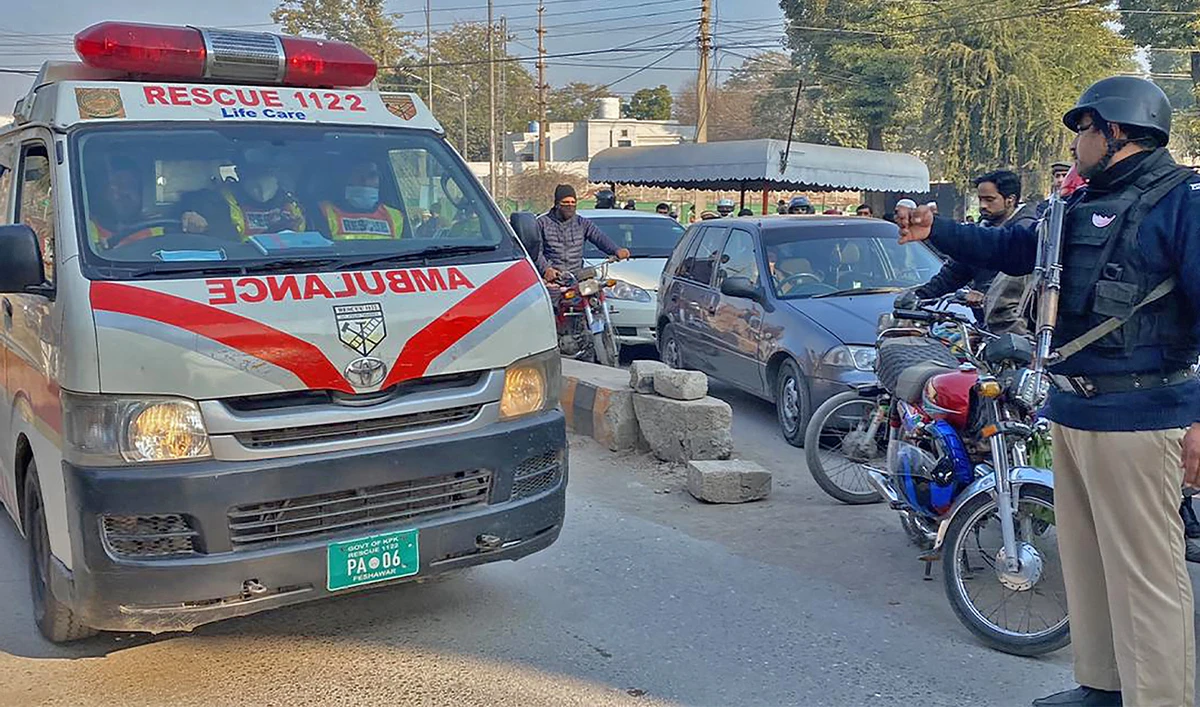 A policeman makes way for an ambulance in Peshawar on January 31, 2023. (AFP/File)