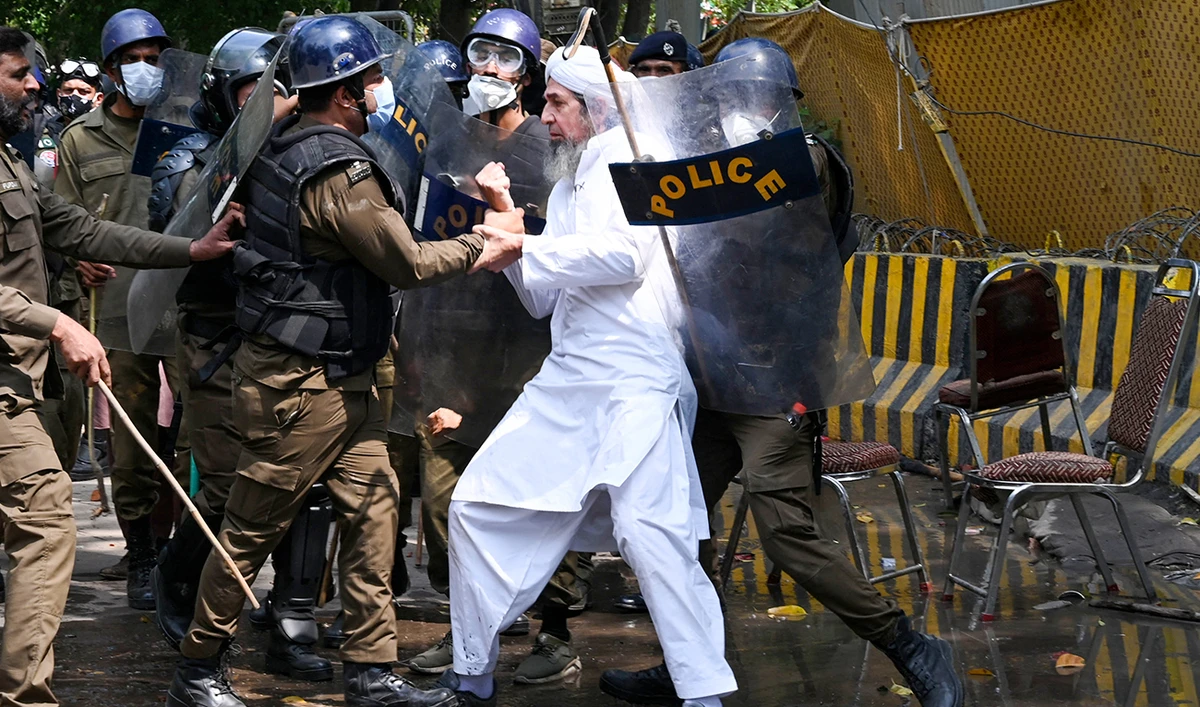 Riot police detain a supporter of Pakistan’s former prime minister Imran Khan, in Lahore on March 18, 2023, whilst Khan was leaving for Islamabad to appear in a court. Pakistan's former prime minister Imran Khan said on March 18 he expected to be arrested as he headed to court on graft charges, after days of legal wrangling and pitched battles between his supporters and police. (AFP/FILE)