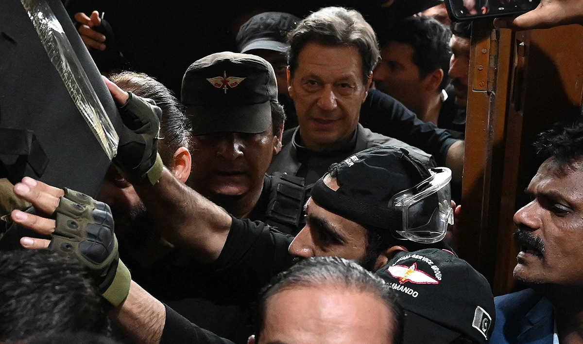 Pakistan’s former prime minister Imran Khan (C) leaves after appearing before a court for a protective bail in relation to two cases, in Lahore on March 21, 2023. (AFP/File)