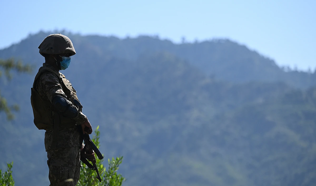 A Pakistani soldier stands guard on a post near the Line of Control, de facto border between India and Pakistan at Salohi village in Poonch district of Pakistan-administered Kashmir on April 26, 2021. (AFP/File)