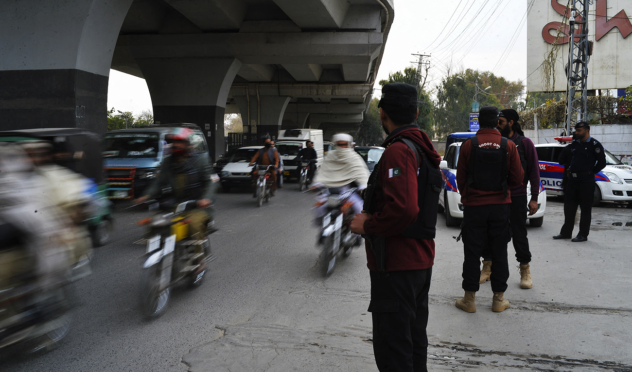 In this picture taken on February 1, 2023, policemen stand guard along a street in Peshawar. (Photo courtesy: AFP/File)