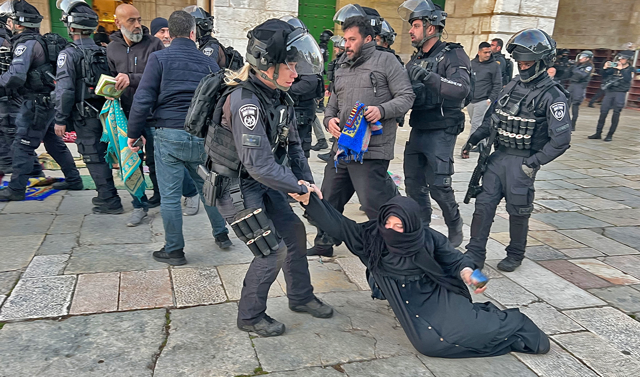 Israeli security forces remove Palestinian Muslim worshippers sitting on the grounds of the Al-Aqsa mosque compound in Jerusalem, early on April 5, 2023 during Islam's holy month of Ramadan. (AFP)