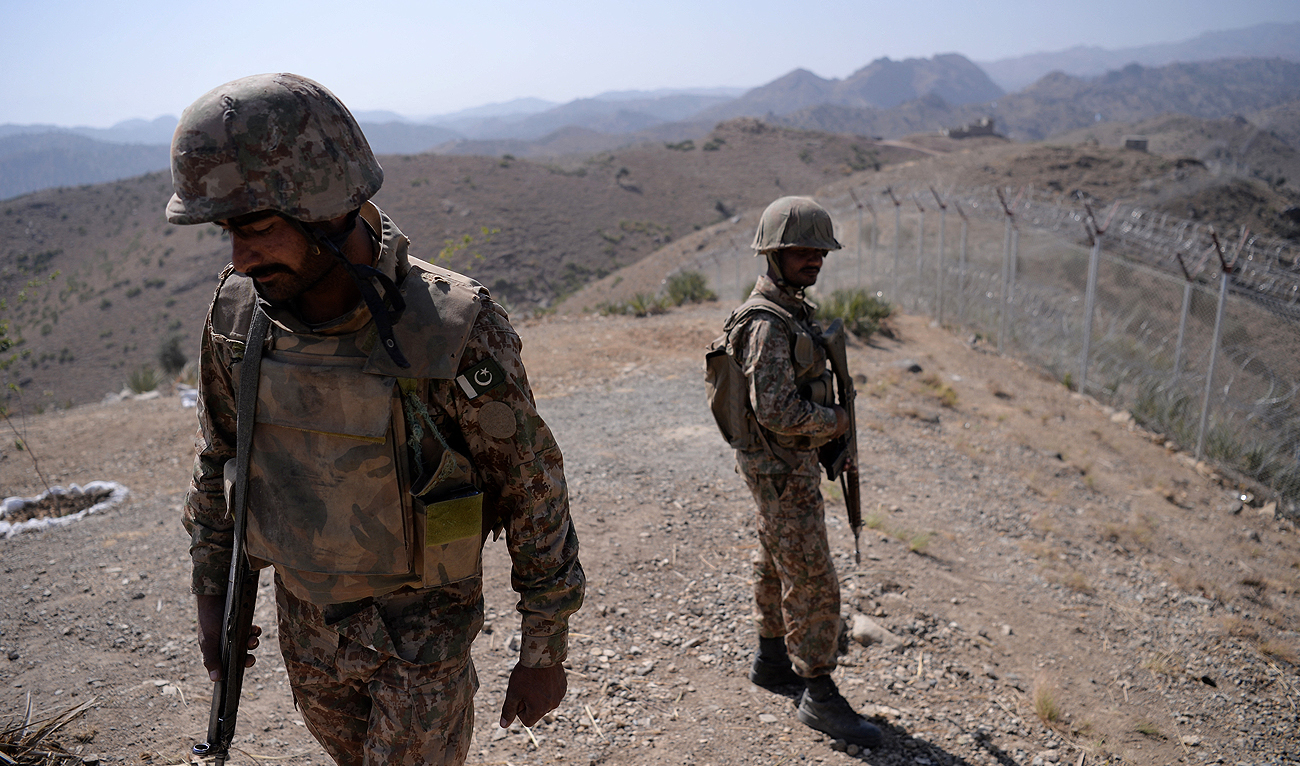In this picture, taken on October 18, 2017, Pakistani soldiers patrol along Afghan border at Kitton Orchard Post in Pakistan's North Waziristan tribal agency. (Photo courtesy: AFP/File)