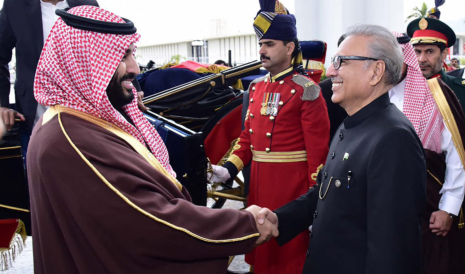 Pakistan's President Arif Alvi (R) shakes hands with Saudi Arabian Crown Prince Mohammed bin Salman (L) as Pakistani Prime Minister Imran Khan (behind) looks on, at the President House in Islamabad on February 18, 2019. (PID/File)