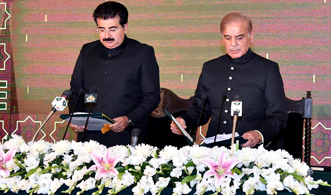 This handout photograph released by the Press Information Department (PID) on April 11, 2022, shows acting Pakistan's President Muhammad Sadiq Sanjrani (L) administering oath to Shehbaz Sharif (R) as Prime Minister of Pakistan at the President House in Islamabad. (AFP/File)