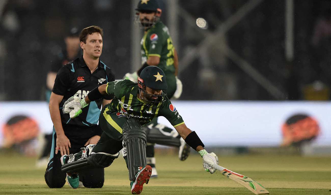 Pakistan's Mohammad Rizwan (R) takes a run during the second Twenty20 cricket match between Pakistan and New Zealand at the Gaddafi Cricket Stadium in Lahore, on April 15, 2023. (Photo courtesy: AFP)
