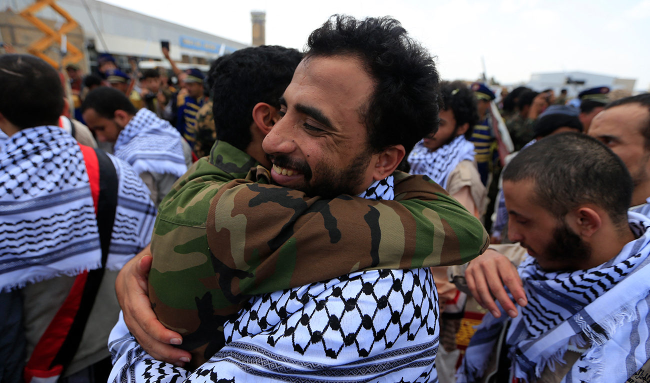 A Yemeni Huthi rebel former prisoner is welcomed upon his arrival at Sanaa airport, on April 16, 2023. Yemeni rebels and government forces freed scores of prisoners on April 16 to end a three-day exchange of nearly 900 detainees and boost hopes of ending their protracted civil war. (AFP/File)