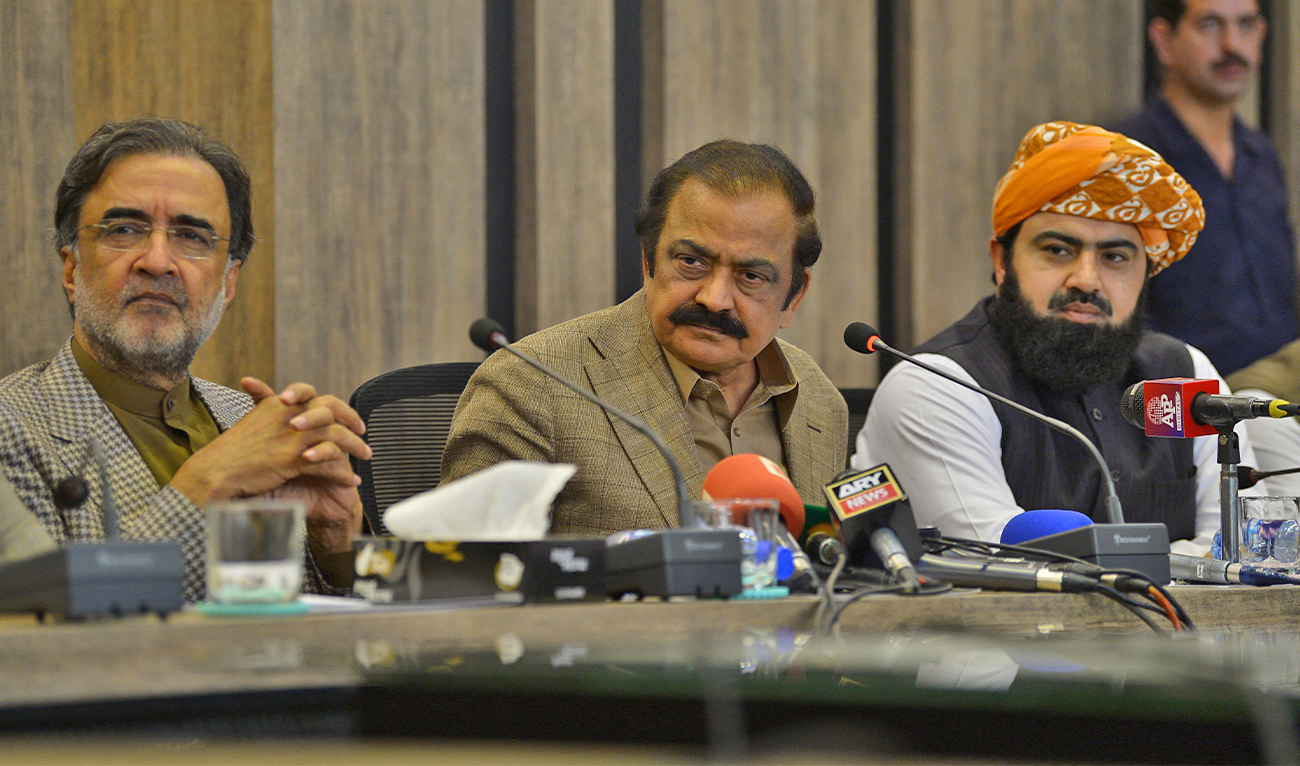 Pakistan Interior Minister Rana Sanaullah (C) along with ruling collation parties leaders Qamar Zaman Kaira (L) and Asad Mehmood (R) listen to a question during a press conference in Islamabad on May 24, 2022. (AFP/File)