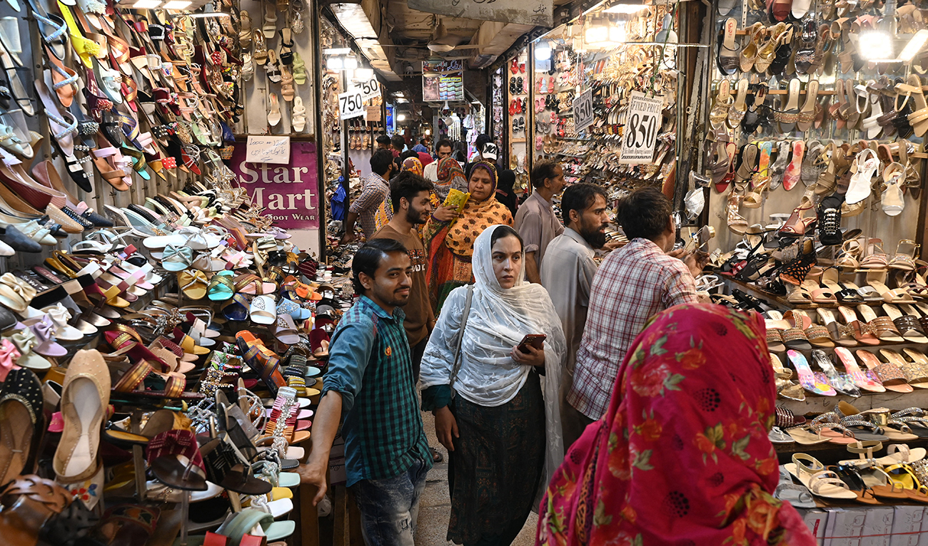 In this picture taken on April 16, 2023, people throng a market during shopping ahead of the upcoming festival of Eid al-Fitr in Lahore. The holiday that marks the end of the Muslim fasting month of Ramadan used to be a guaranteed earner for Pakistan's small shops and businesses -- a big-spending week that could match the take from the rest of the year. (AFP/FILE)