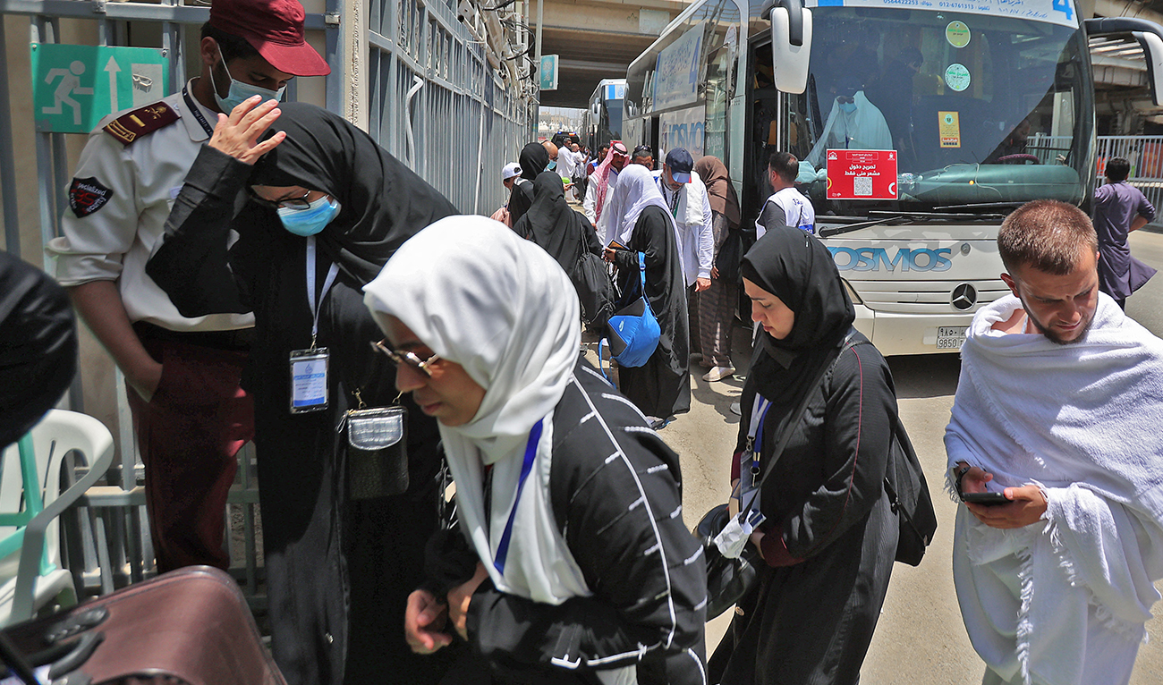 Muslim women pilgrims arrive to their camp in Mina near the Saudi holy city of Mecca on July 7, 2022 during the annual Hajj pilgrimage. (AFP/FILE)
