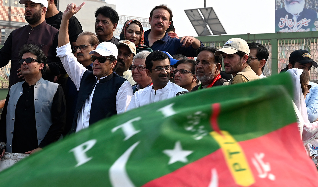 Pakistan's former prime minister Imran Khan (4L) gestures to his supporters during an anti-government march towards Islamabad city, demanding early elections, in Muridke district, about 29 km from Lahore on October 30, 2022. (AFP/File)