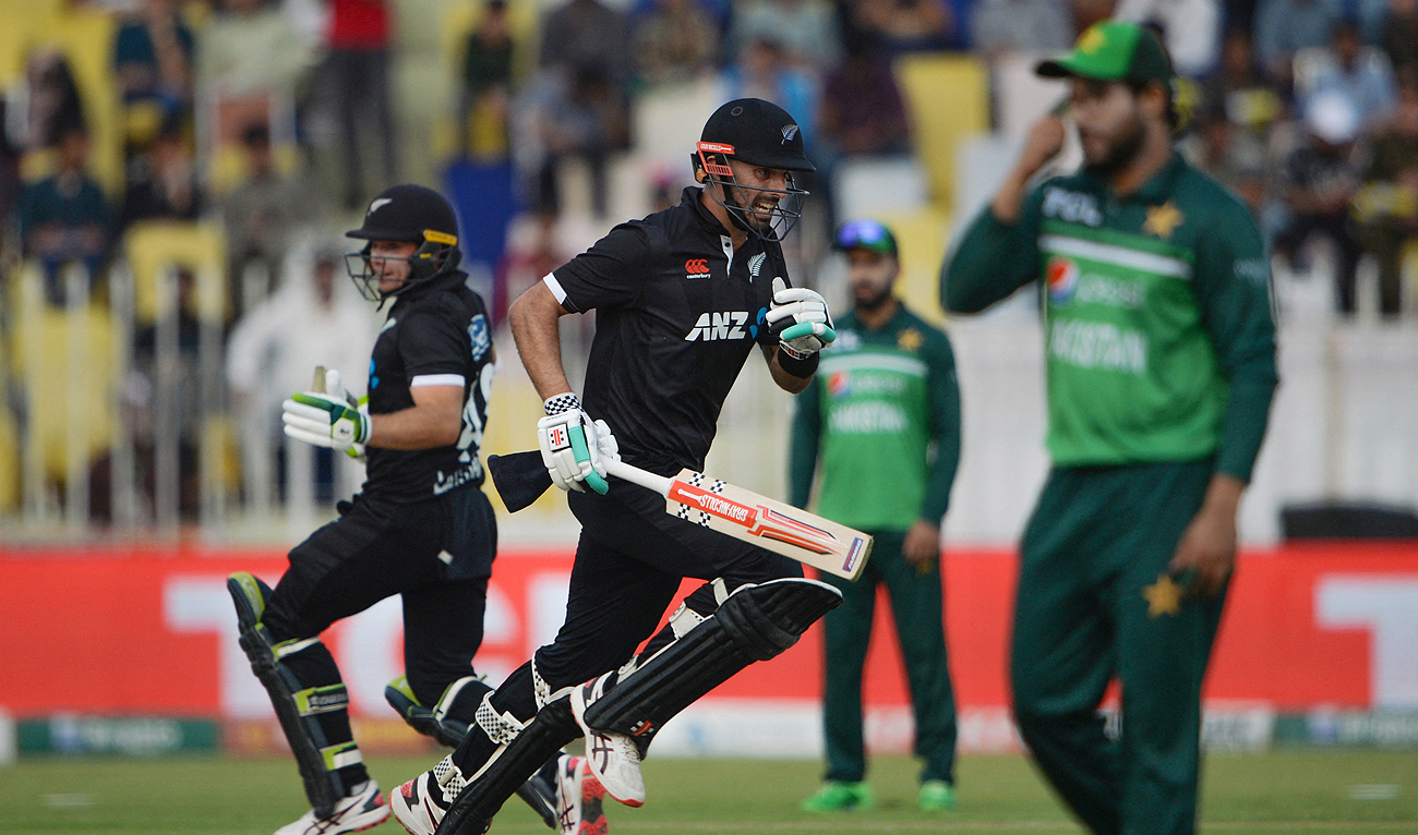 New Zealand's Daryl Mitchell (C) and Tom Latham (L) run between the wickets during the second one-day international (ODI) cricket match between Pakistan and New Zealand at the Rawalpindi Cricket Stadium in Rawalpindi on April 29, 2023. (Photo courtesy: AFP)