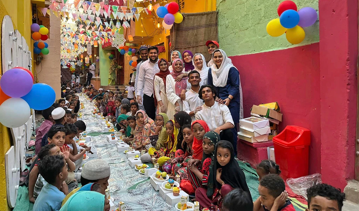 The image posted on March 25, 2023, shows organisers of the welfare group and children posing for a picture before an iftar meal in Karachi’s Lyari neighborhood. (Sabina Khatri/Facebook)